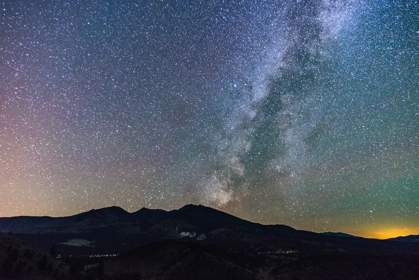 The Milky Way arching over the dark silhouette of the San Francisco Peaks near Flagstaff