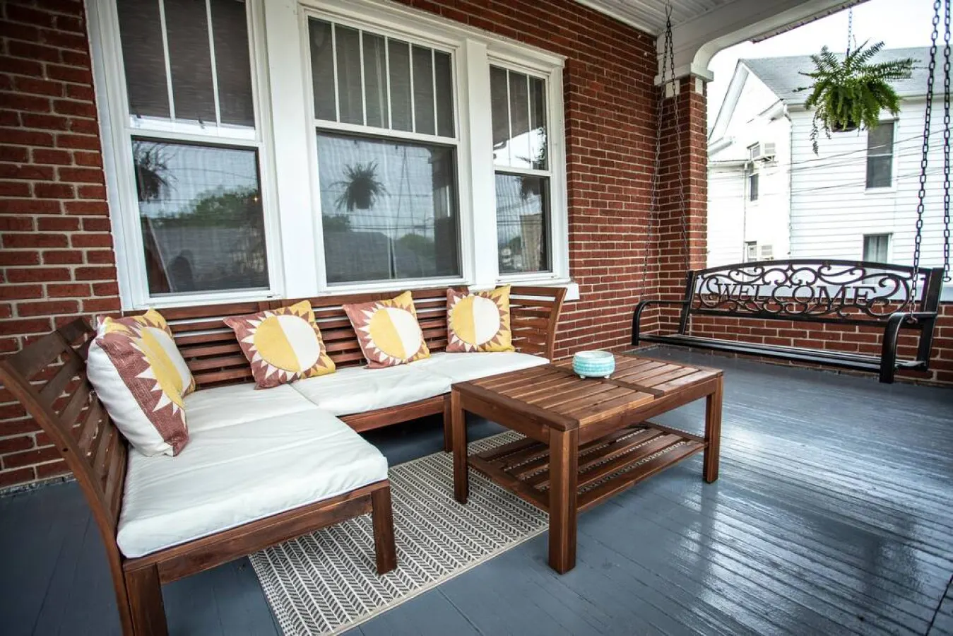 Relax on our covered front porch. We have a swing, sectional, and coffee table for your use. Not pictured is our grill, which you can bring out from the carriage house.