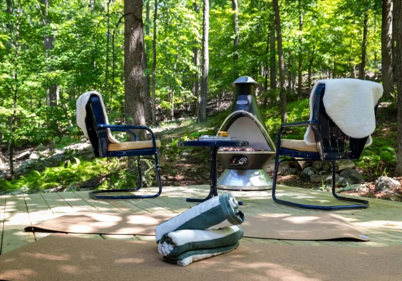 The deck area houses two chairs, a side table, and a gas chiminea to warm you up on the cooler evenings. There are yoga mats on the screened in porch for morning sun salutations.